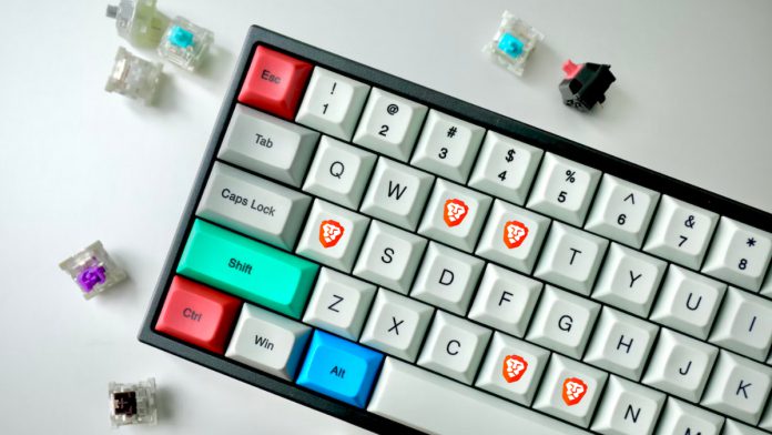 Mechanical keyboard with brave browser stickers on keys B, R, A, V, E.